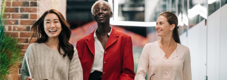 3 women walking and smiling