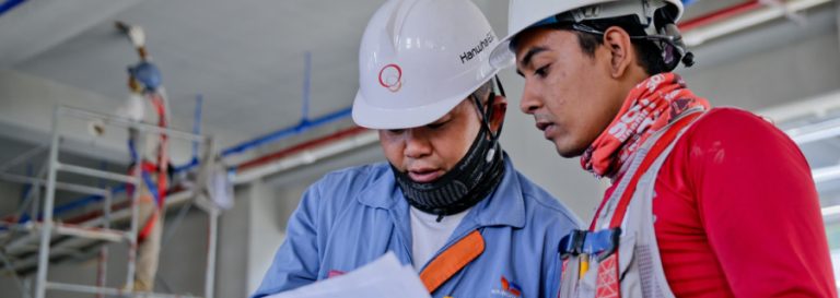 2 tradesmen looking at a document together