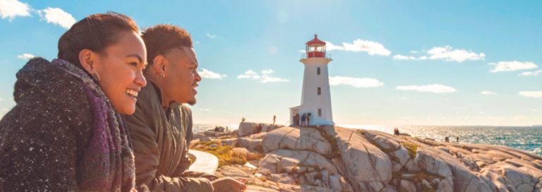 A young indigenous woman and a young black man at Peggy's Cove