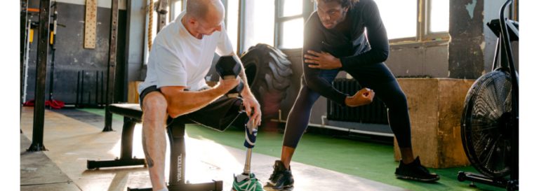 Personal trainer and client working on arm strength