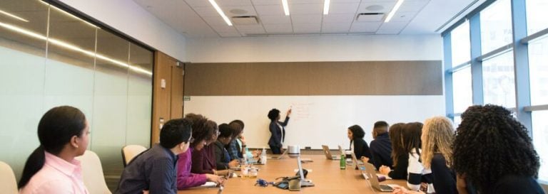 Large group in boardroom facing presenter