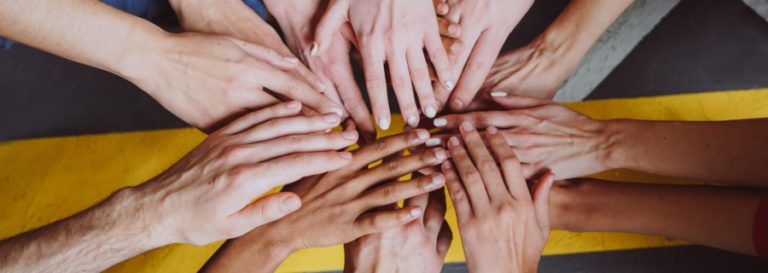 hands stacked on one another